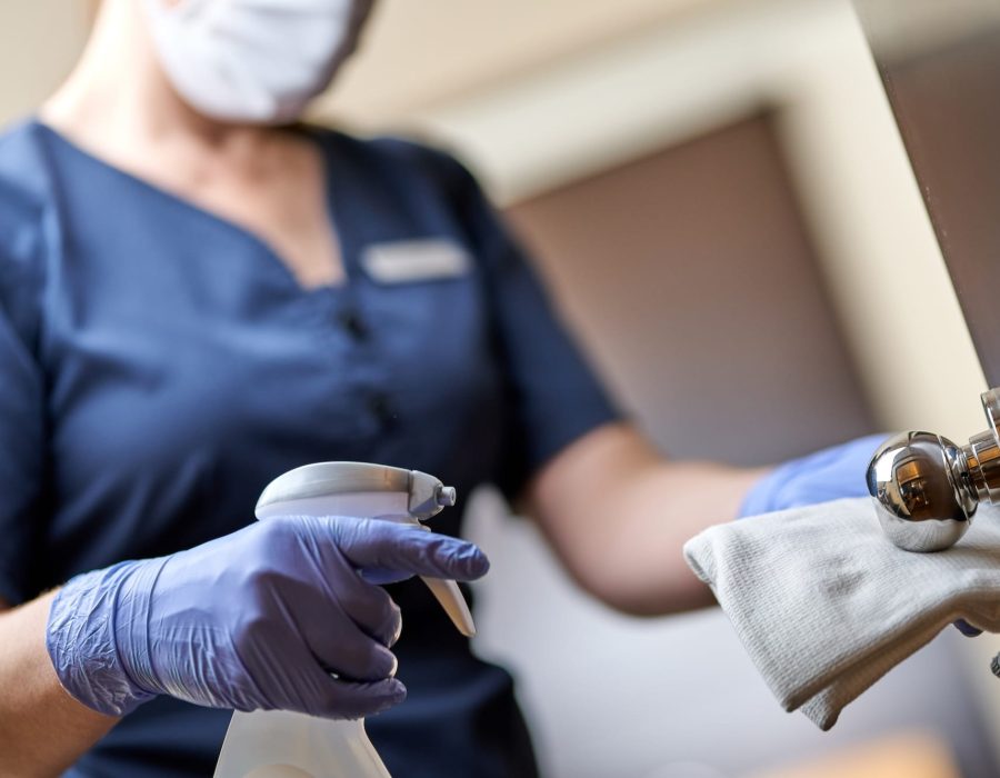 maid-in-mask-doing-disinfecting-the-door-handle-in-2025-03-26-22-59-35-utc.jpg